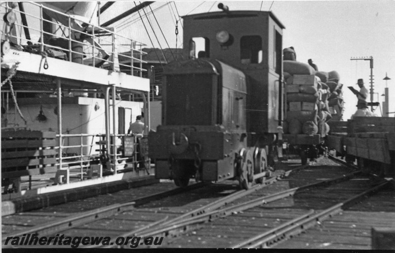 P14450
PWD loco PW31, jetty with State ship Kolinda berthed, Wyndham, view along the jetty.
