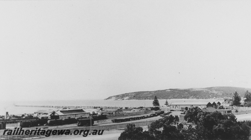 P14501
Yard, Esperance, CE line, view across the yard showing sheds, jetty, tankers in the yard carrying fuel for the Lake View & star mine in Kalgoorlie.
