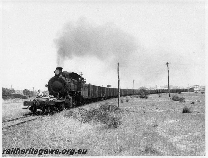 P14663
F class propelling a NS class shunters float hauling a long train of high sided wagons, location Unknown
