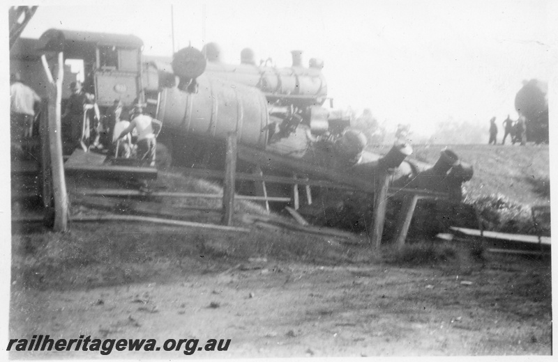 P14692
5 of 10, ES class 332 derailed on 10/6/1951, lying in a creek at Wooroloo, ER line, a PR class loco in the background, 
