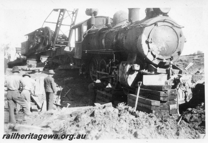 P14697
10 of 10, ES class 332 derailed on 10/6/1951, lying in a creek at Wooroloo, ER line, a breakdown crane lifting the loco and jacking it up on sleepers, 
