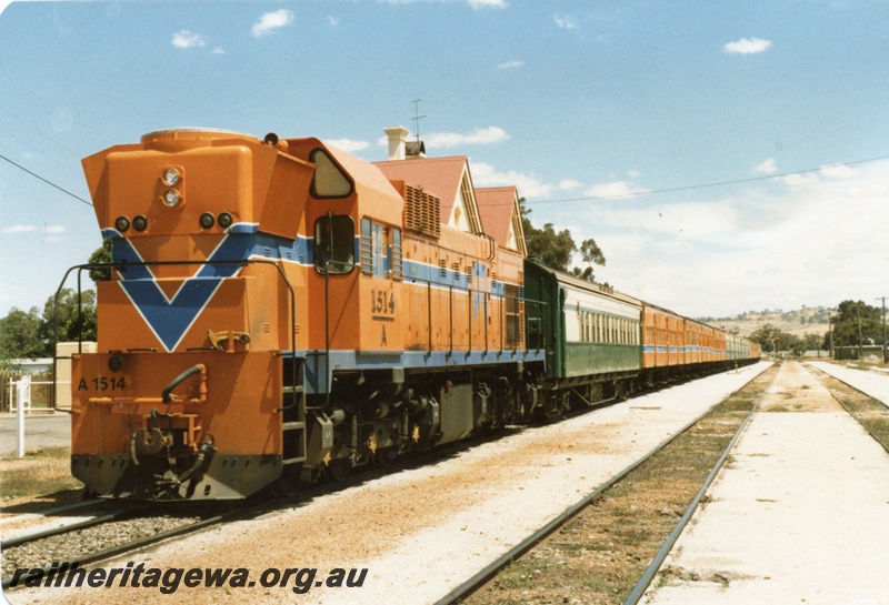 P14713
A class 1514 diesel locomotive in Westrail orange livery, front and side view, on passenger train, York, GSR line.
