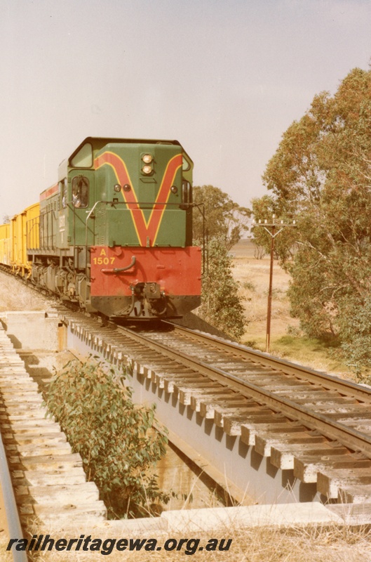 P14721
A class 1507 diesel locomotive in green with red and yellow stripe livery passing over a culvert, front view, York, GSR line.
