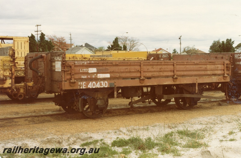 P14730
HE class 40430 low-sided wagon in brown livery, end and side view, Bassendean, ER line.

