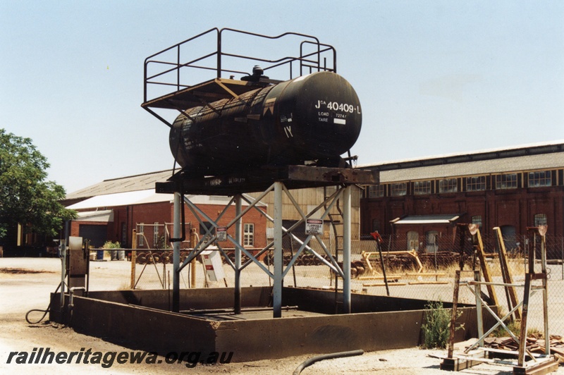 P14750
Tank from JOA class 40409-L being used as an elevated tank at the Midland Workshops, side and end view
