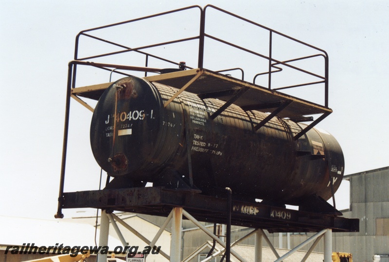 P14751
Tank from JOA class 40409-L being used as an elevated tank at the Midland Workshops, end and side view
