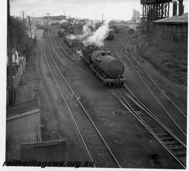 P14830
G class 223 steam locomotive shunting, tracks, round house and water tower, Bunbury, SWR line.
