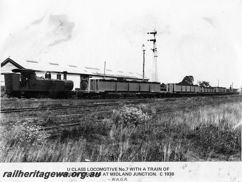 P14872
U class 7 steam locomotive, side view, with a train of bridge girders, Midland Junction, semaphore signals, ER line
