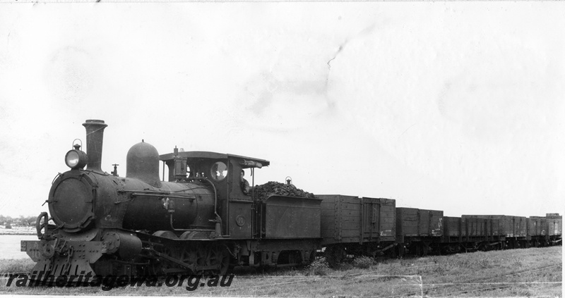 P14873
A class 10 steam locomotive, GE class 7429 high-sided goods wagon, Bunbury, SWR line, c1930.
