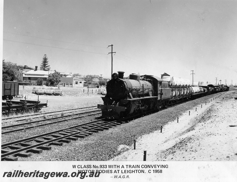 P14874
W class 933 steam locomotive on goods train loaded with car bodies and other goods, semaphore signal, Leighton, ER line, c1958.
