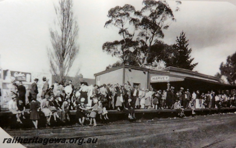 P14895
Station building, track side view, large crowd on the platform, Harvey, SWR line, c1920s.
