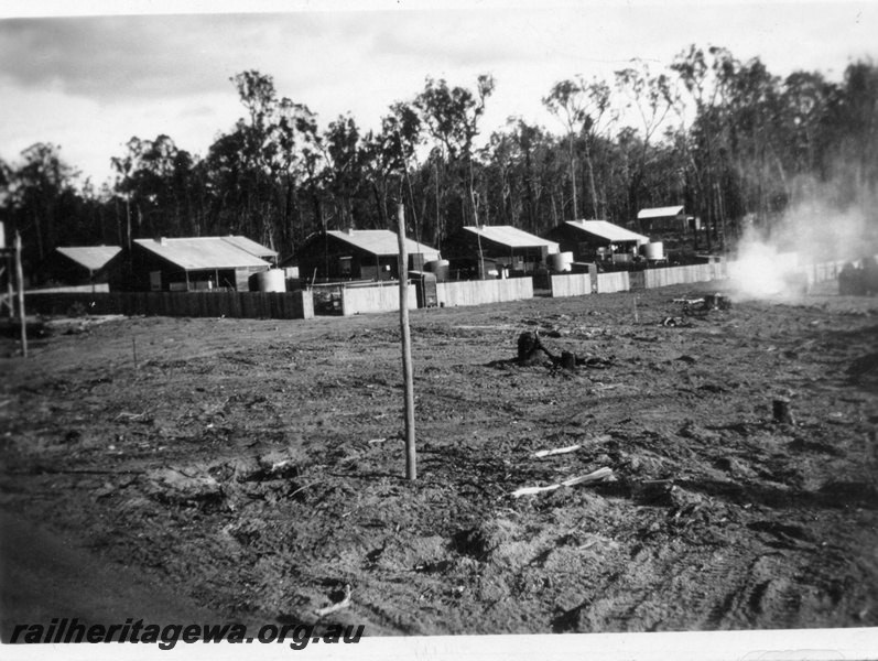 P14925
Row of mill houses at Nyamup, cleared ground in the foreground is for more houses.
