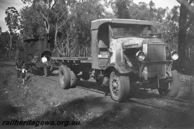 P14935
2 of 2 views of a truck being positioned over the rails to haul the loco 