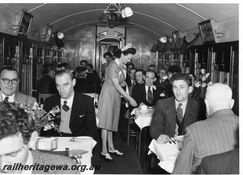 P14977
AV class Dining Car, interior view, with Waitress attending to passengers.

