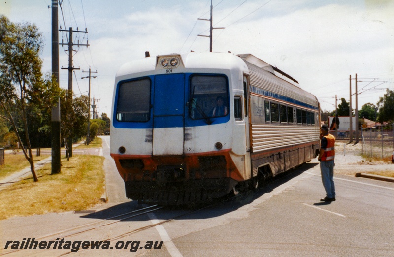 P15020
WCA class 901 Prospector power car crossing Railway Parade, Bassendean about to enter the site of the Rail Transport Museum, front and side view.
