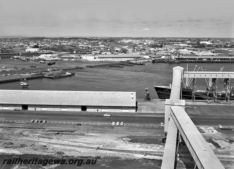 P15042
Rail bridge, being dismantled, barges, cranes, 10 Berth in foreground with trackwork, grain elevator, ship docked, Fremantle Port, view south from North Quay across the harbour, c1964
