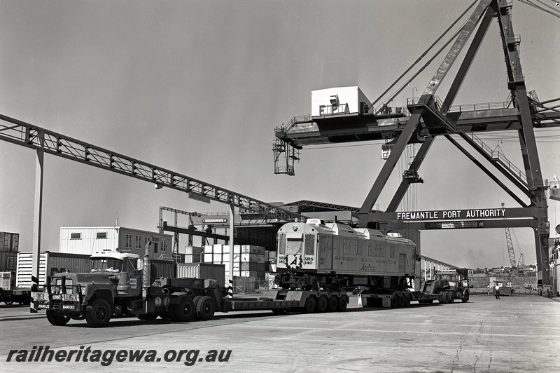 P15049
Sperry Rail Service railcar 140, on semi-trailer, Brambles Manford prime mover XJJ236, Fremantle Port Authority crane,12 Berth, North Quay, Fremantle Port, end and side view
