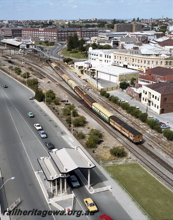 P15053
Hotham Valley Railway W class loco, on excursion train, moving away from camera, approaching Fremantle station, bracket signal, light signal, Elders warehouse, Victoria Quay exit gate, Fremantle station, ER line, aerial view
