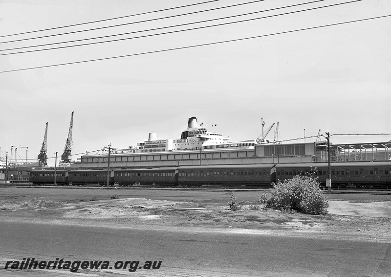 P15062
Rake of passenger carriages comprising one AD class car and four dogbox cars, on siding adjacent to Fremantle Passenger Terminal, side view, 