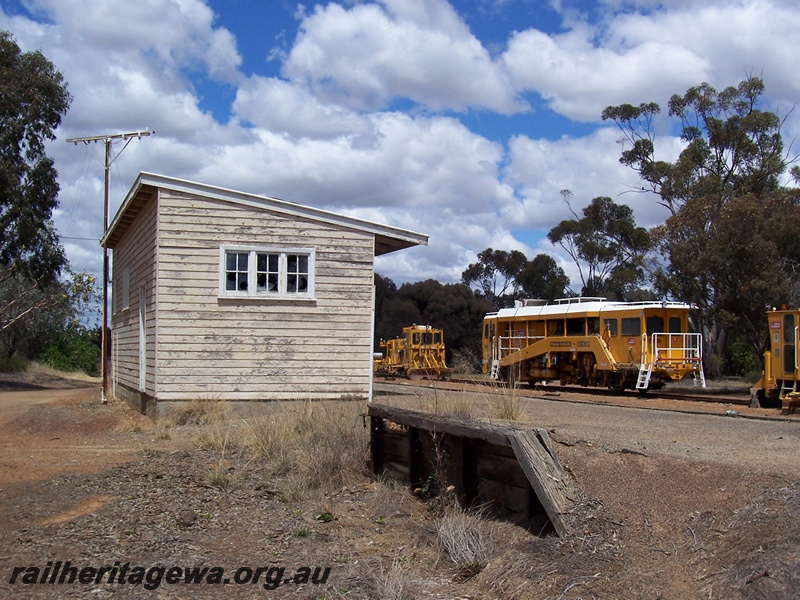 P15089
Station building, telegraph pole, Woodanilling, GSR line, rear and side view, track maintenance vehicles on the loop
