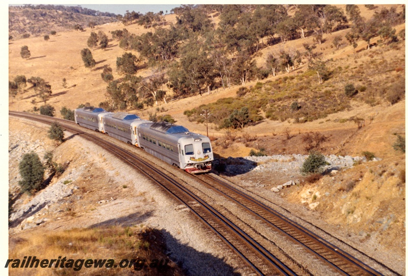 P15107
An unidentified 3 car Prospector set travelling towards Perth in the Avon Valley. Cars are in original paint scheme and an overhead view of the cars roofing.
