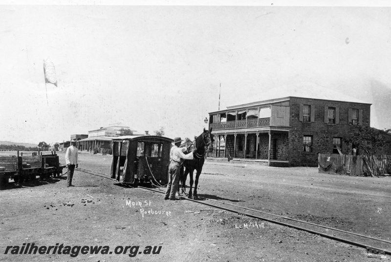 P15112
Roebourne horse tram is depicted opposite the Victoria Hotel, the first stopping point on the journey to Cossack
