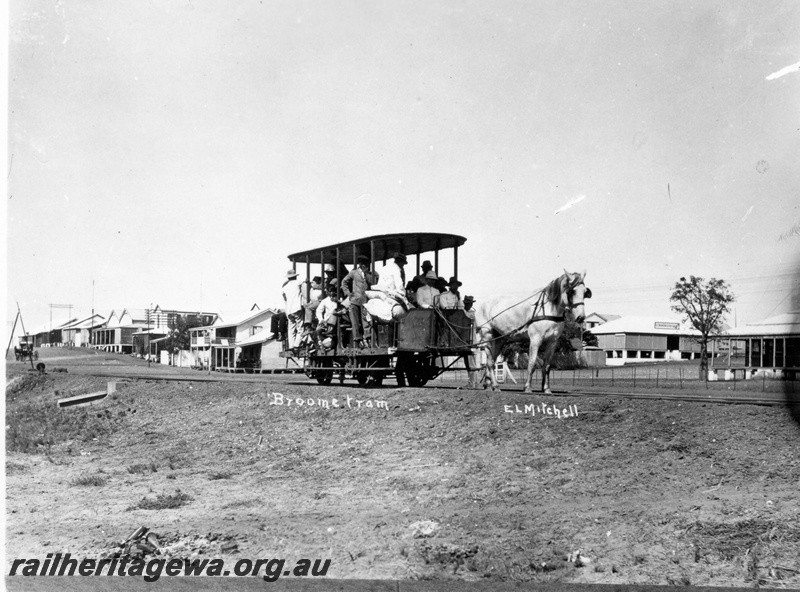 P15114
A horse drawn tram pictured in Broome with a sizeable crowd. Portion of the township in the background.
