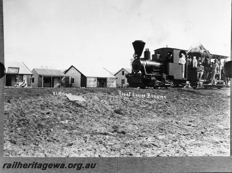 P15115
An unidentified steam locomotive, Broome's first with a loaded tram car. Part of the 'housing estate' in the background.
