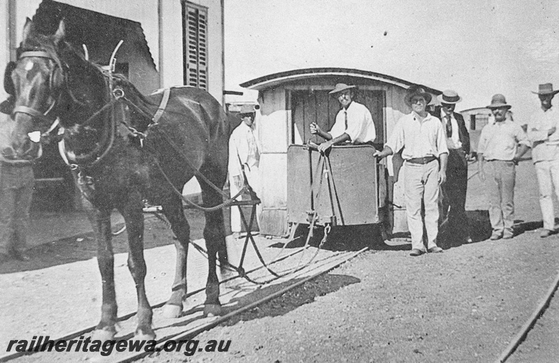 P15116
A horse drawn tram at possibly Roebourne. Note the attire of the bystanders and tram driver.
