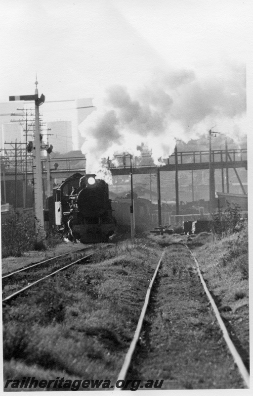 P15121
PMR class 734 departing Bunbury with 42 goods train. Note semaphore signal at left, overhead footbridge in background. SWR line.
