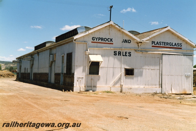 P15159
1 of 2 views of the disused goods shed at Northam, ER line, with the tracks removed being use as a depot for 