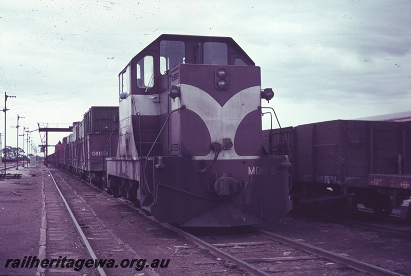 P15212
Commonwealth Railways (CR) MDH class 5 shunting wagons under the gantry crane at Parkeston, TAR line, mainly a front on view of the loco.
