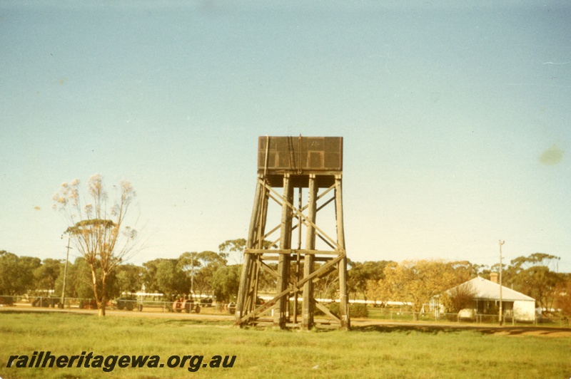 P15256
Water tower with a black painted 25,000 gallon cast iron water tank, farm machinery, house, Cunderdin, EGR line, all that remains of the railway yard
