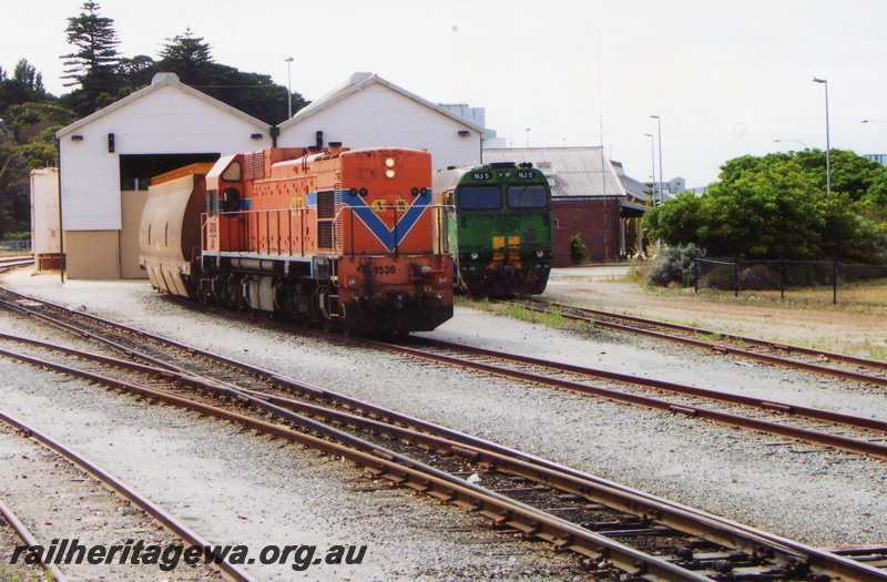P15283
AB class 1536, in Westrail orange and blue colour scheme but with Australia Western Railroad initials and swan logo, NJ class 5 in green and gold livery, sheds, Albany, GSR line
