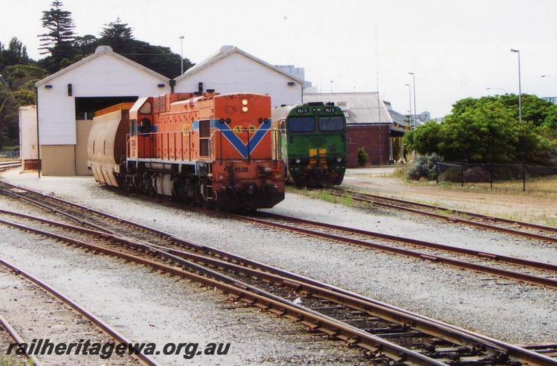 P15283
AB class 1536, in Westrail orange and blue colour scheme but with Australia Western Railroad initials and swan logo, NJ class 5 in green and gold livery, sheds, Albany, GSR line
