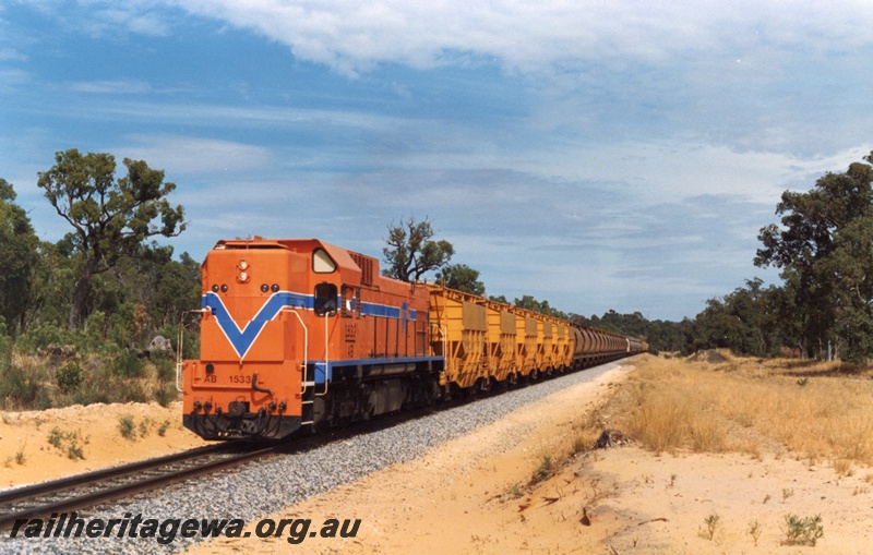 P15378
AB class 1533 in the Westrail orange with the blue stripe livery hauling a mineral sands train between Yarloop and Wagerup.SWR line, The train consists of WME and XE class wagons.
