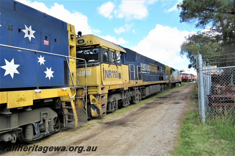 P15400
Pacific National loco, NR class 110 and AN class 9 trailing NR class 46, on the line passing through the site of the Rail Transport Museum departing after delivering Mineral Resources loco MRL class 003 to UGL's plant, Bassendean, front and side view
