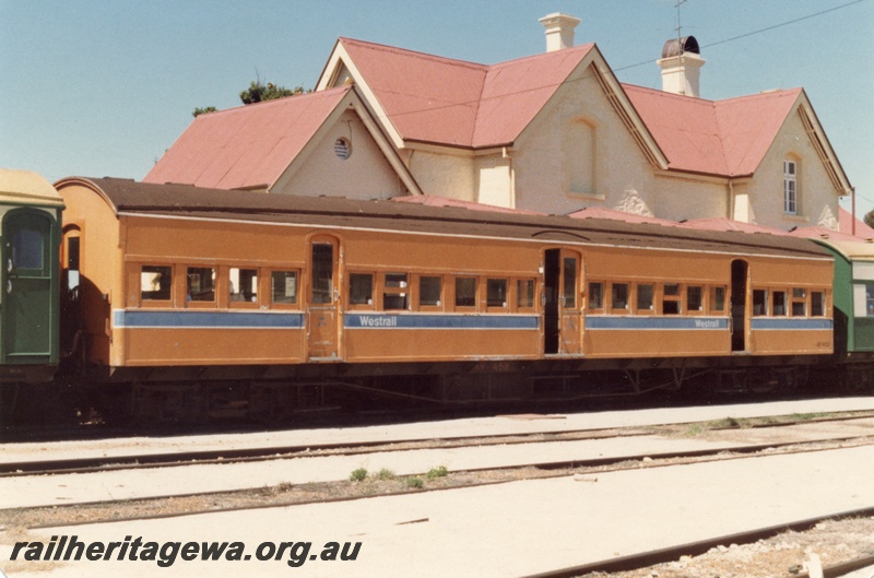 P15419
AY class 453 suburban carriage, in Westrail orange and blue livery, end and side view, station building behind the carriage, on ARHS tour train to York, GSR line
