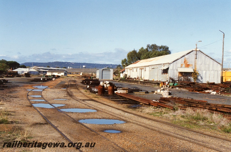 P15462
The Westrail Rail Siding with large shed with a loading platform, piles of rails and other items scattered around the site, Bellevue, general view from the entrance to the site
