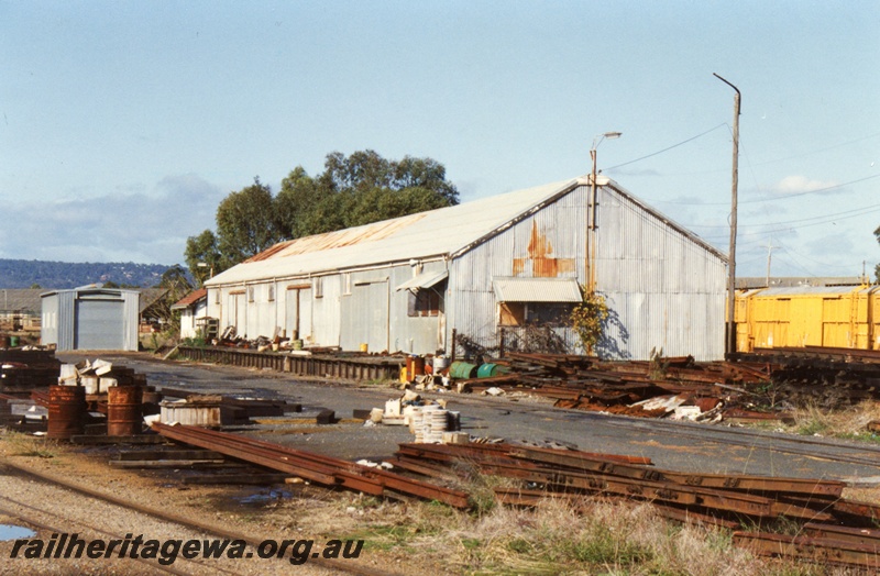 P15463
The Westrail Rail Siding with large shed with a loading platform, piles of rails and other items scattered around the site, Bellevue, general view from the entrance to the site, Closer view than in P15462

