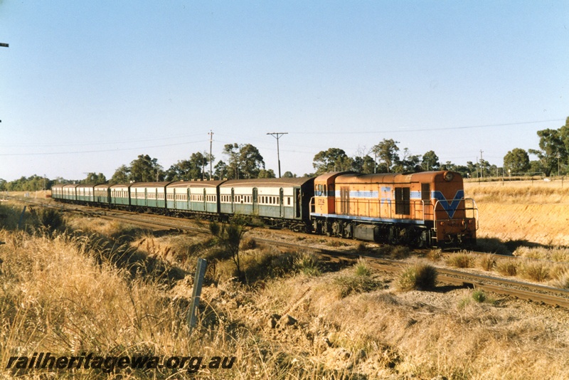 P15493
C class 1702 hauls a rake of wooden bodied suburban carriages in the green and cream livery through Hazelmere towards Midland on the last day of services for these carriages
