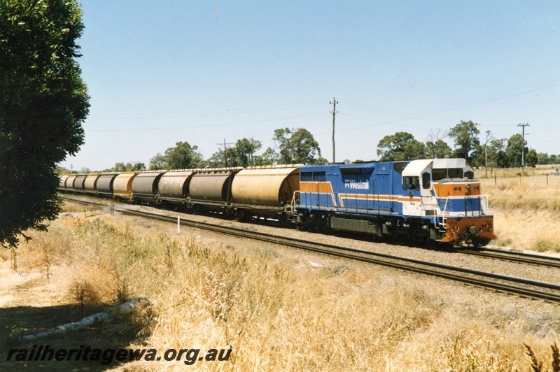 P15504
L class 268 in the blue, orange and white livery heads a grain train through Hazelmere towards Midland, view along the train
