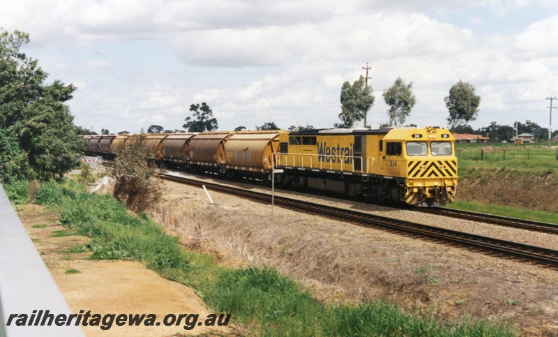 P15506
Q class 314  (reclassified Q class 4014) in the Westrail Yellow livery hauls an empty grain train through Hazelmere northwards towards Midland, view along the train
