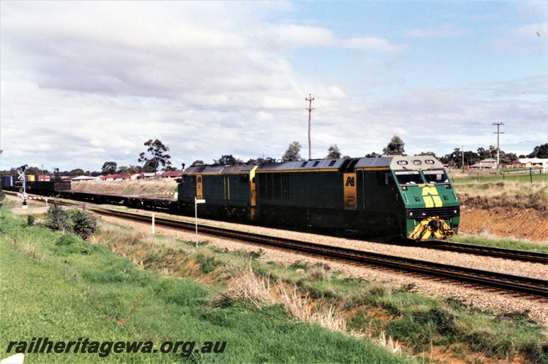 P15508
Australian National EL class 60 and a DL class heading a freight train northwards through Hazelmere towards Midland, view along the train
