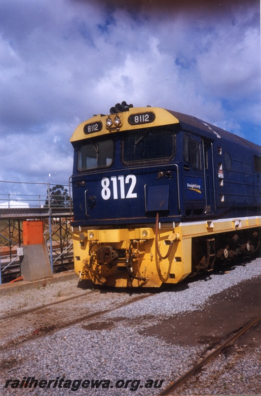 P15599
National Rail ex NSWR 81 class 8112 in the blue livery with yellow stripe along the side, Kewdale, front and partial side view
