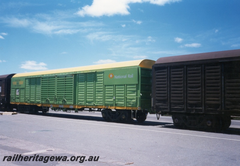 P15613
Sadliers NLKY class in the green livery with a yellow stripe along the lower edge of the side, Kewdale, mainly a side view
