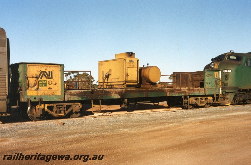 P15614
Australian National AZGY6V bogie open wagon with cut down sides, green livery with a yellow panel on the side, Parkeston, mainly a side view, heavily weathered

