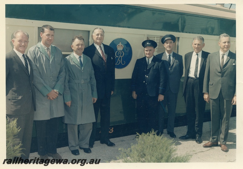 P15627
WAGR officials and train stall posing in front of AN class 413 Vice Regal carriage carrying the Queen Mother to Bunbury. From the left are Mr. J. Pascoe, Chief Traffic Manager, fourth from the left, Mr. C. G. C. Wayne, Commissioner of Railways, eighth from the left, Mr. W. Blakeney Britter, Chief Mechanical Engineer

