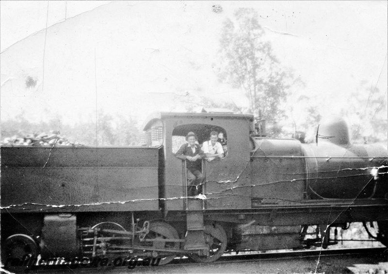 P15634
M class 388 Garratt, driver J. Parr and J. McInerney looking out of the cab, Pinjarra, SWR line, side view of cab and the bunker, c1937
