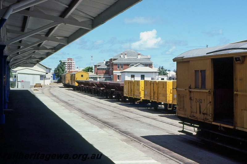 P15643
Part view of Z class 463-Y brakevan in the all over Westrail yellow livery with a silver roof, GEF class wagons on the next track, Geraldton yard, NR line, view along the yard.
